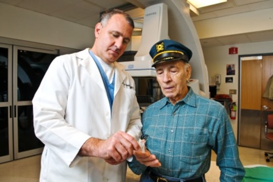 Dr. Petrossian shows Anthony Leto the CoreValve implant.